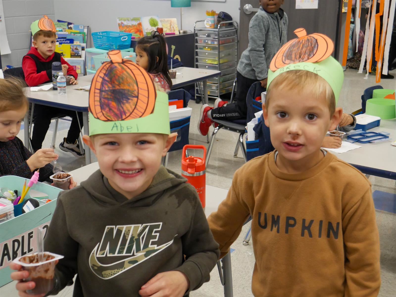 Two boys in pumpkin hats